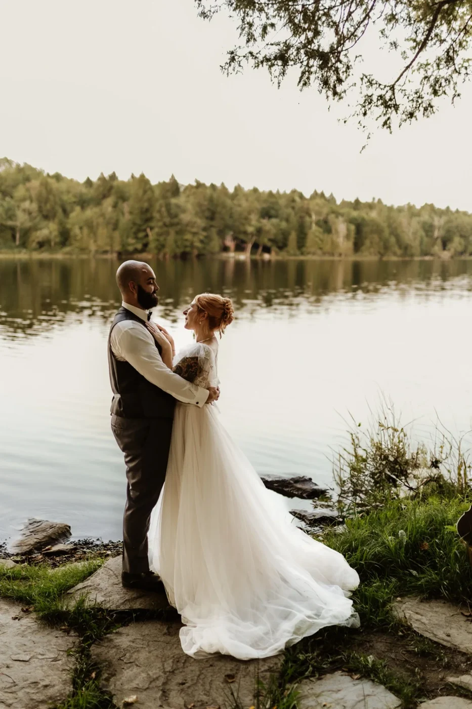 A newly married couple beside the lake at Dragonwood in Maine